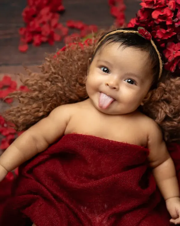 A cheeky little tongue-out moment from this adorable infant. I love capturing these fleeting expressions that show off your baby's budding personality.
