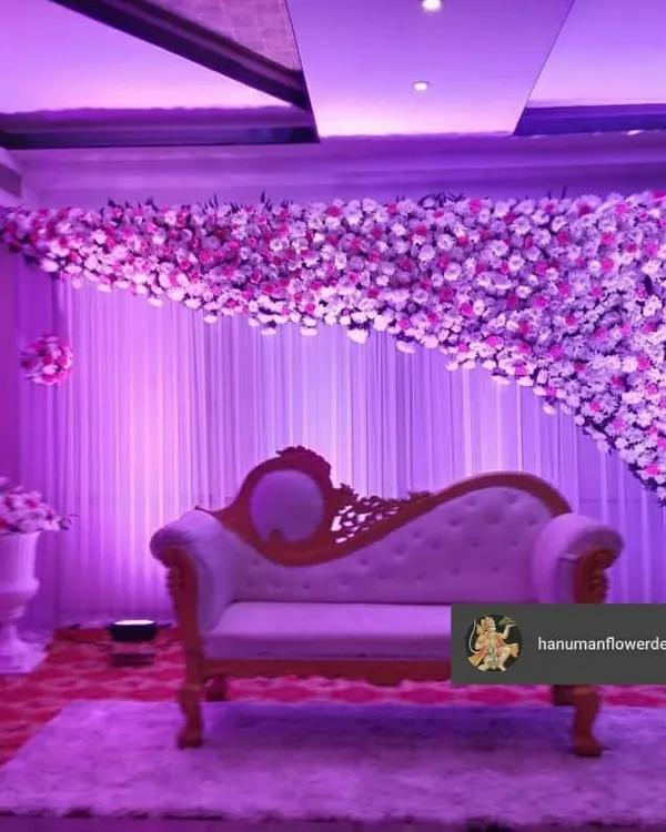 This beautiful floral stage was the centerpiece of a corporate gala. The cascading flower wall, paired with dramatic purple lighting and an elegant chaise lounge, created a perfect photo opportunity for guests.