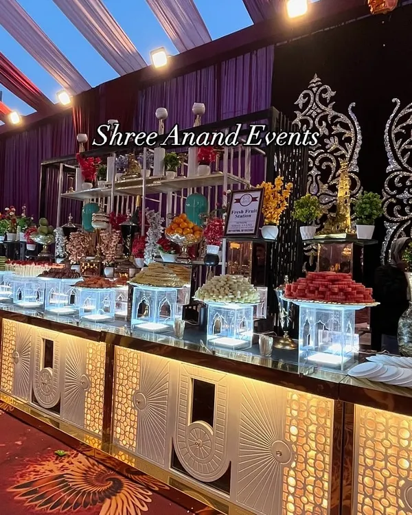 A glimpse of the magnificent fruit and dessert displays I create. This lavish spread features an abundance of fresh fruits, intricate carvings, and bite-sized sweets, all presented on illuminated multi-level counters to create a true feast for the eyes.