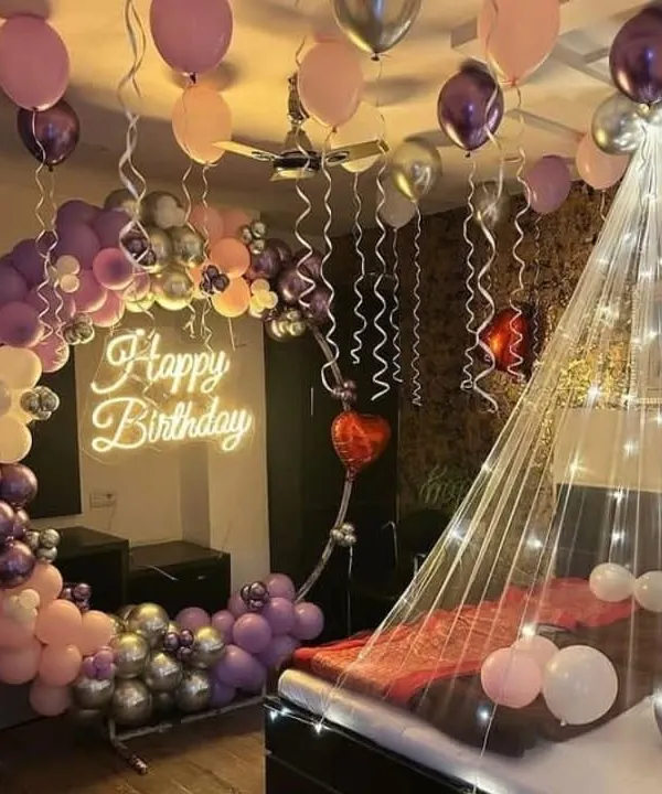 I combined all the best elements for this birthday surprise. The setup features a custom balloon half-arch, a glowing "Happy Birthday" neon sign, and a romantic bed canopy with fairy lights to create a truly magical atmosphere.