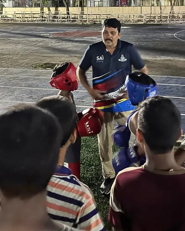 I believe in teaching from the ground up. Here, I'm instructing a group of our youngest boxers on the fundamentals of stance and guard before we even start punching.