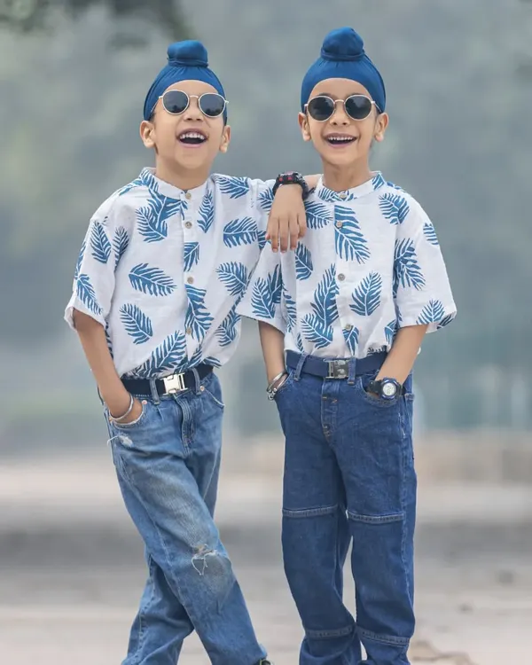 Twinning! These two brothers are looking super cool in their matching outfits during an outdoor shoot. Their confidence and bond are amazing to see.