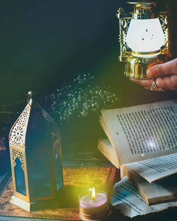 A moody and atmospheric still life with old books, lanterns, and candlelight. This shot is all about creating a feeling of mystery and nostalgia through careful styling and dramatic lighting.