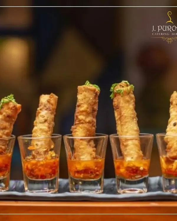 I love creating fusion appetizers like these crispy spring rolls served in shot glasses with a sweet chili dipping sauce. This modern presentation is both stylish and convenient for guests.