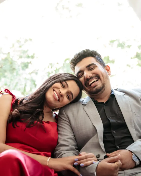 The beauty of a genuine laugh. This tight close-up captures a moment of pure, unscripted happiness and connection between the couple.