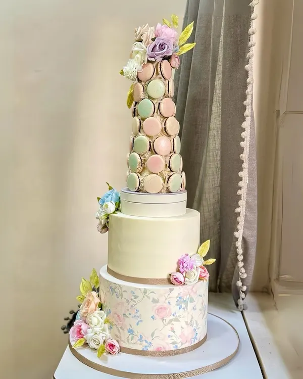 This three-tiered cake, adorned with a pastel macaron tower and delicate sugar flowers, was crafted for a truly magical celebration. It represents my passion for creating grand, statement pieces for life's most important moments.