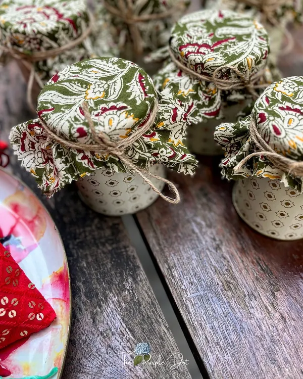 Tradition meets tomorrow in these beautifully detailed jars. The lids are covered in classic Indian block-print fabric and tied with simple jute string, a perfect blend of rustic charm and timeless design for wedding favors or festive gifts.
