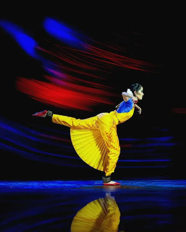 A dynamic moment captured on stage, using light painting to emphasize the energy and motion of the performance. This technique adds a layer of emotional intensity to the visual narrative.