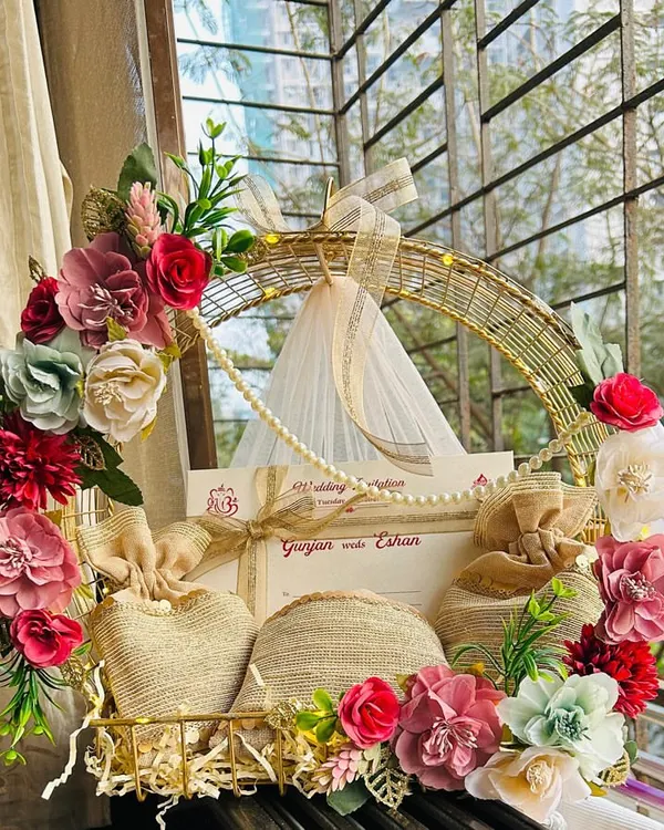 This is what first impressions are all about. I designed this wedding invitation hamper to be a breathtaking floral announcement, combining the formal invite with sweet treats in jute potlis, setting a tone of luxury and warmth for the celebrations ahead.