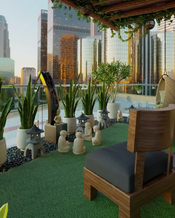We designed this zen balcony as a peaceful escape from the city. The space features artificial turf, low-maintenance snake plants, miniature pagoda statues, and comfortable wooden seating, creating a tranquil corner for meditation or relaxation.