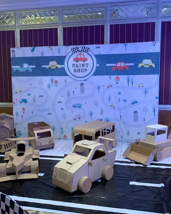 Welcome to my world of imagination. Here is a full 'Paint Shop' I created for a birthday party, complete with a fleet of cardboard vehicles ready for little artists to customize. This is how I turn any event into a creative adventure.