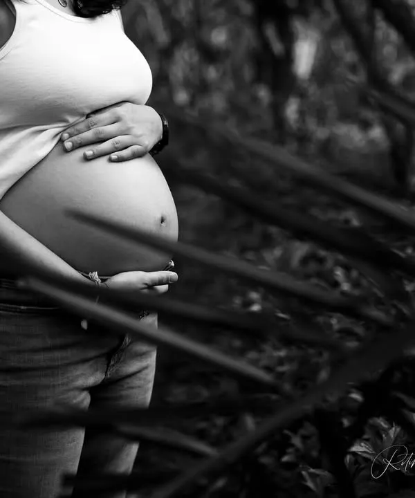 In black and white, the focus shifts to form and emotion. This artistic shot zeroes in on the beautiful curve of the baby bump, a simple and powerful tribute to the life growing within.