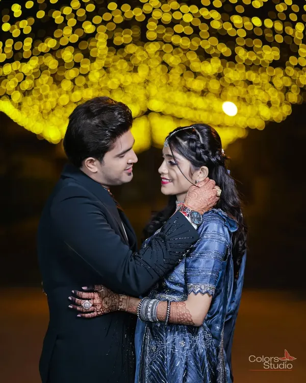 A romantic portrait under an arch of golden lights, creating a beautiful bokeh effect.