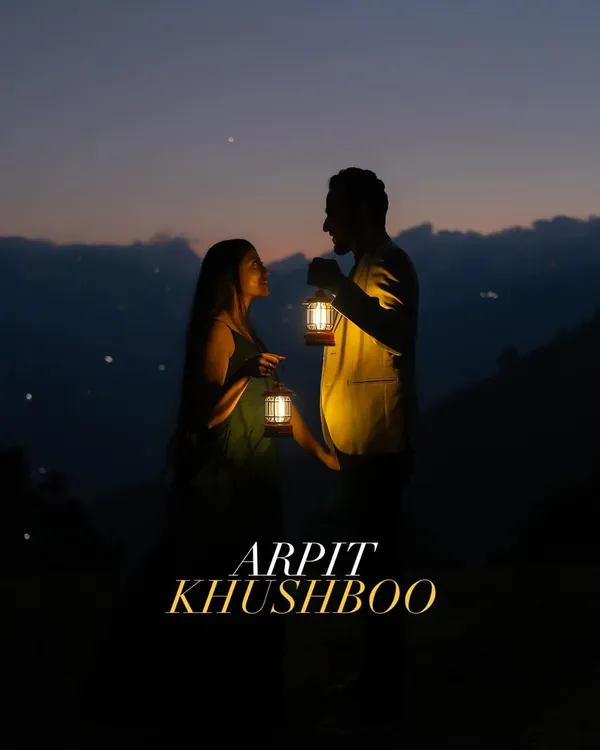 A signature shot from our night pre-wedding sessions. The couple is illuminated only by the warm glow of lanterns under a starry mountain sky, creating an image that is both intimate and epic.