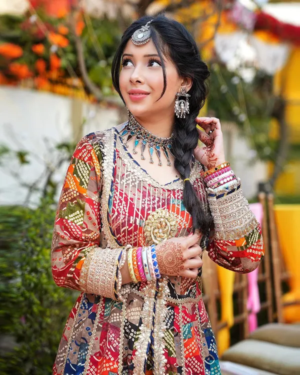 This is the kind of look I love creating for a Mehendi or Haldi ceremony. The vibrant colors of this Banjara-style outfit, paired with oxidized jewelry and a classic braid, create a memorable and festive wedding guest look.