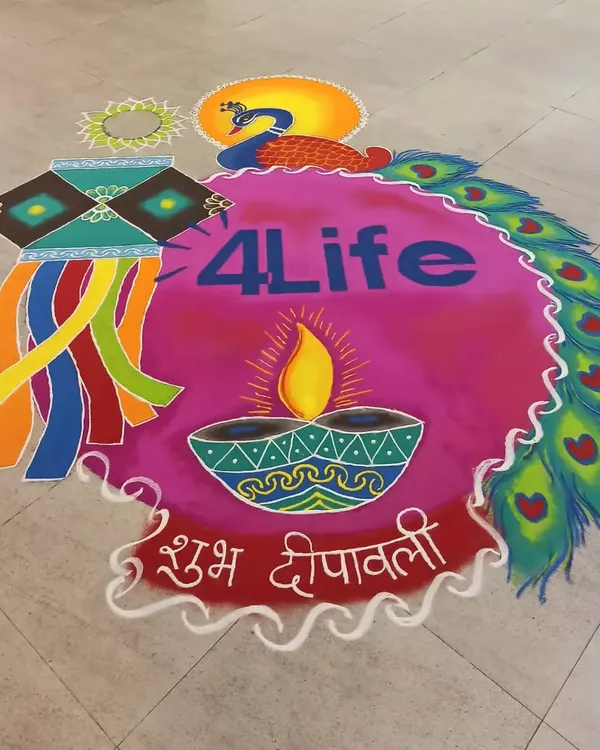 A complete view of a large-scale corporate rangoli created for Diwali. The design incorporates the company logo, a central diya, a kandil, and a border of peacock feathers, all in a bright, welcoming color palette.