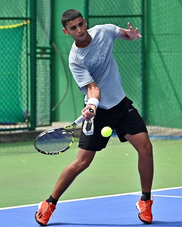 This action shot captures the intensity and focus of a player dominating the point. This is the kind of aggressive, on-the-front-foot tennis we train for.