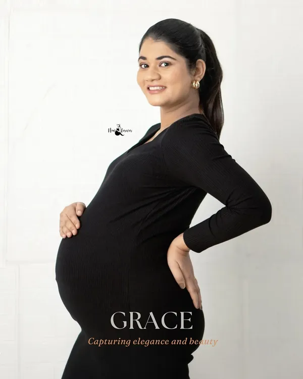 A simple, elegant portrait in a classic black dress. The focus is entirely on the mother-to-be and her beautiful silhouette. This style is timeless and chic.