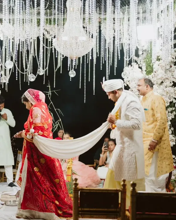 The sacred 'pheras' are the heart of the ceremony. I designed this breathtaking mandap with arches of white cherry blossoms and a ceiling of hanging crystals and florals, creating a magical, ethereal space for the couple to take their seven steps.