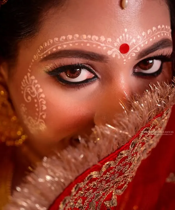 This is the essence of Bengali bridal beauty. I focus on capturing the soul through the eyes, highlighting the intricate 'Chandan' art that tells a story of tradition and grace. This kind of intimate, powerful portrait is a cornerstone of my work.