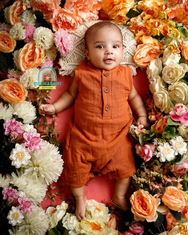 Two months old is a magical time when they start to interact more. We captured this baby's bright-eyed curiosity in a beautiful floral nest.