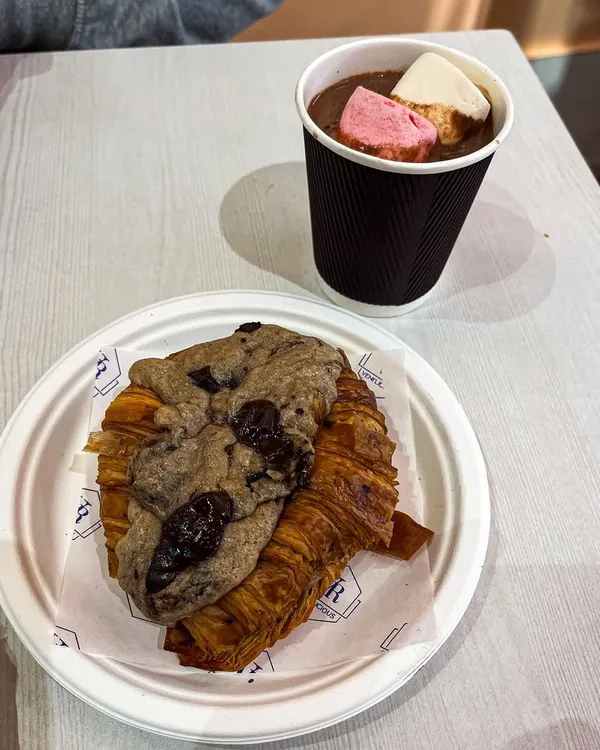 The perfect pair for a cozy evening. Our viral Crookie served alongside a cup of thick hot chocolate topped with marshmallows.