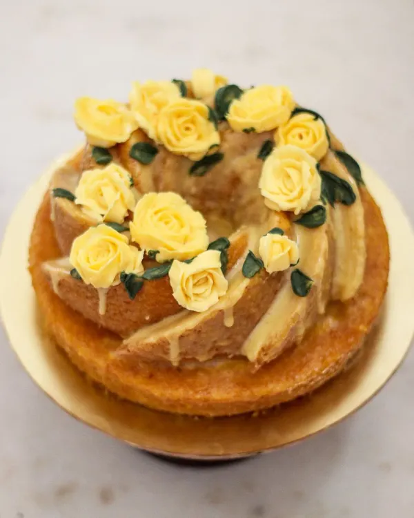 A dressed-up bundt cake for a Jane Austen themed party! This soft vanilla bundt with a crunchy sugar glaze and buttercream roses is perfect for an elegant celebration.