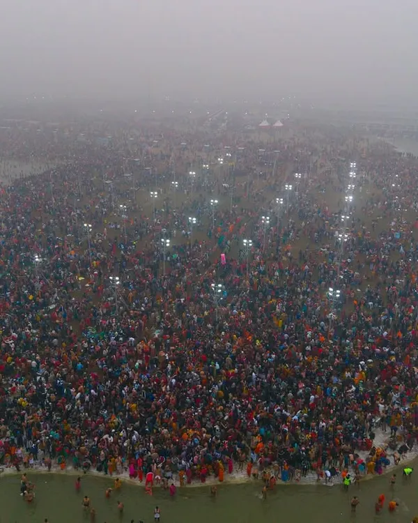 An early morning at the Mahakumbh Mela during the first holy dip, or Paush Purnima Snan. The fog and the lights create a mystical atmosphere over the massive crowd at the Sangam.