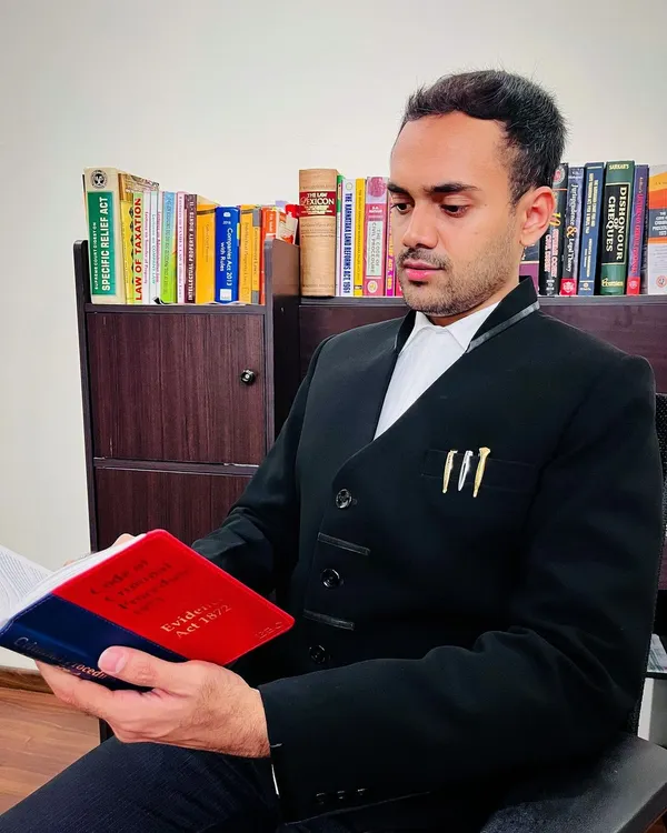 In my office, reviewing the Evidence Act. A lawyer's work never truly ends, as staying updated with the nuances of the law is critical to success.