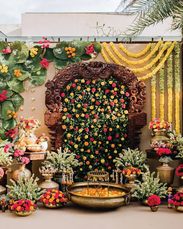 The centerpiece of this Haldi ceremony was a stunning antique Prabhavali, which we filled with a dense arrangement of marigolds and greenery. The entire setup is a vibrant celebration of colour and tradition, featuring brass urlis and floral arrangements.