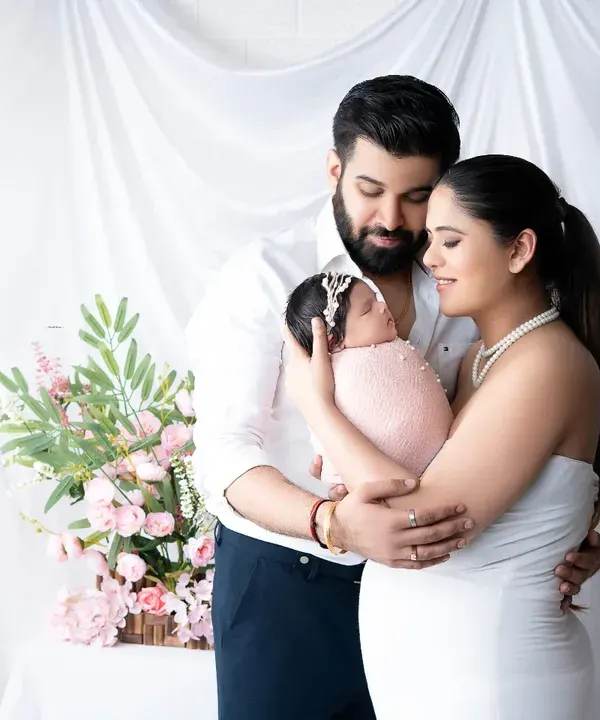 Welcoming their newborn daughter with a tender family embrace. This bright and airy newborn family portrait captures the pure love and joy of the first few days as a new family.