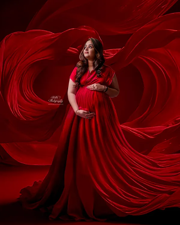 This is the kind of magic we create in the studio. A powerful portrait for a powerful journey, using a gorgeous flowing red gown and dramatic lighting to celebrate the beauty of motherhood.