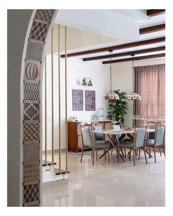 A view from the foyer of the 'Spanish Country Home,' looking into the dining area. The design transformed an old penthouse into a cozy casa with Spanish flair, blending Mediterranean sensibilities with Indian touches.