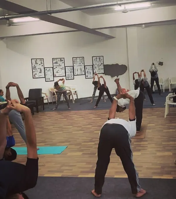 Our shooters engaging in yoga stretches designed to improve flexibility and core strength, which are vital for maintaining a stable shooting stance for long durations.