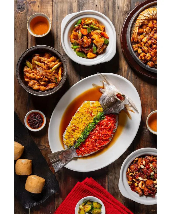 A comprehensive flat lay for the new menu at Shang Palace, Shangri-La Eros Delhi. This shot captures the variety and artistry of their main courses, including a signature steamed fish dish, showcasing my ability to style and photograph complex table scenes.