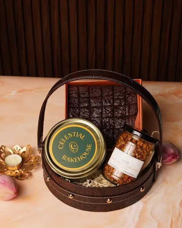 Our Raksha Bandhan Gift Basket, filled with eggless brownies, handcrafted granola, and choco-chunk cookies, all packed in a stylish leatherette basket.