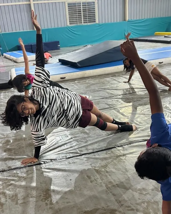Building a strong core is fundamental. Our students work on exercises like this side plank, which is essential for stability in all gymnastic movements.