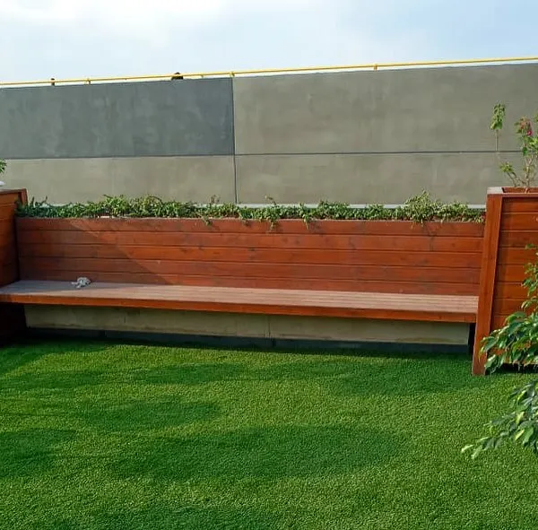This custom-built wooden bench is designed with planters at each end, seamlessly integrating seating with greenery for a functional and beautiful garden feature.