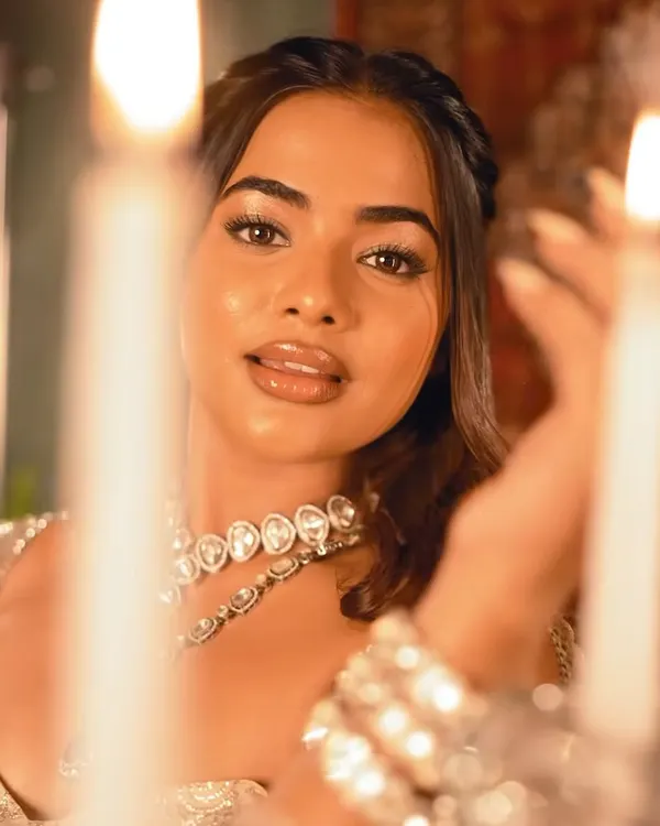A high-fashion, queenly look from a creative shoot. The focus is on luminous, glass-like skin, a glossy nude lip, and a simple braided hairstyle, creating a look of pure royalty.