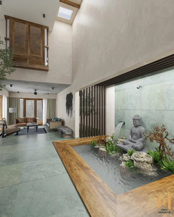 This is what we mean by a home that tells a story. We designed this rustic contemporary villa with a serene indoor fish pond and a tranquil Buddha statue, creating a peaceful oasis right at the entrance. The double-height ceiling and live tree next to the solid wood dining table bring nature indoors, making the entire space feel open, airy, and connected to the earth.