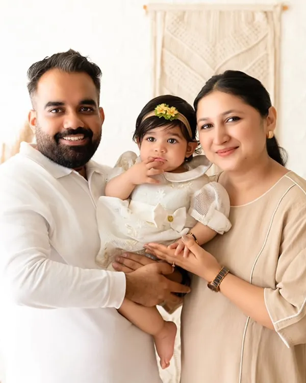A warm family portrait in my boho-themed studio. The neutral color palette and natural textures create a relaxed and airy vibe for lifestyle family photography.
