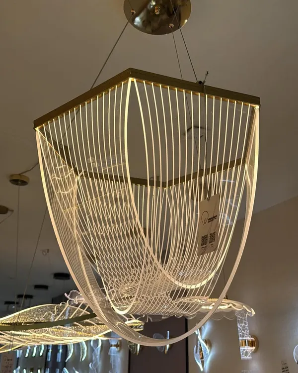 This modern chandelier uses flowing lines of light to create a sense of movement. It's a true work of art that looks stunning over a large dining table or in a high-ceiling entryway.