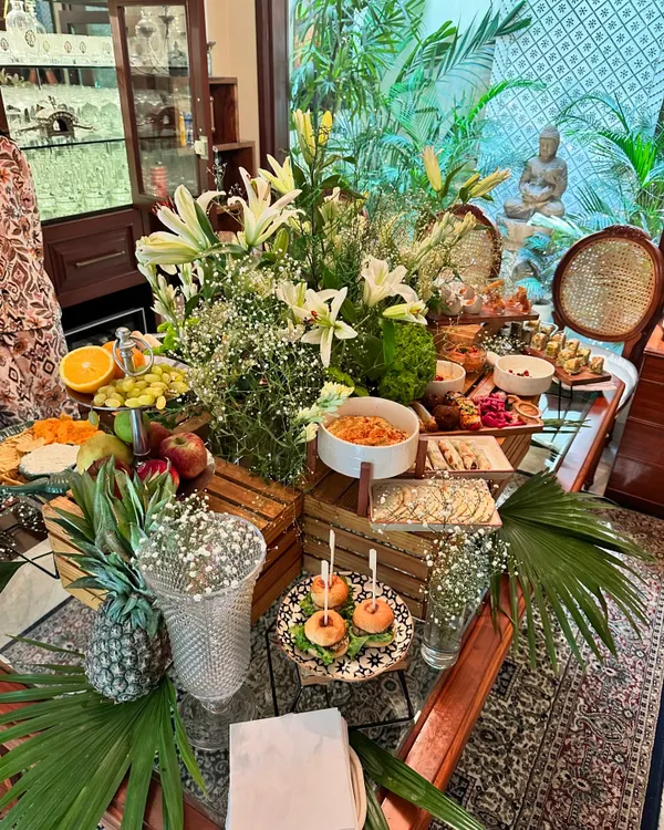 This is the vibe we bring to every event. A lush, artfully styled grazing table we created for a festive house party, featuring an abundance of artisanal cheeses, fresh fruits, charcuterie, mini sliders, and beautiful floral arrangements.