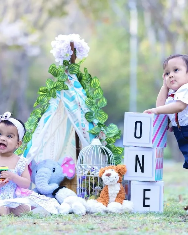 A whimsical first birthday celebration for twins. I styled this outdoor session with a teepee, "ONE" blocks, and cuddly toys to create a fun and memorable setting for their milestone portrait.