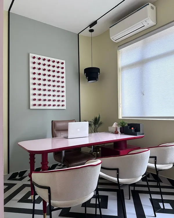 A view of a personal cabin within my studio, featuring a custom-made pink desk and a bold geometric floor. This space is designed to spark creativity and shows how I can incorporate unique personality into a professional setting.