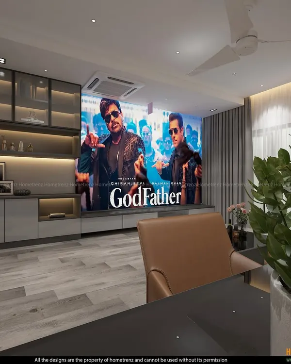 This living room doubles as a high-performance home theater. A large projector screen descends in front of the custom cabinetry, which houses the audio components and provides elegant storage, creating a seamless transition from living space to cinema.