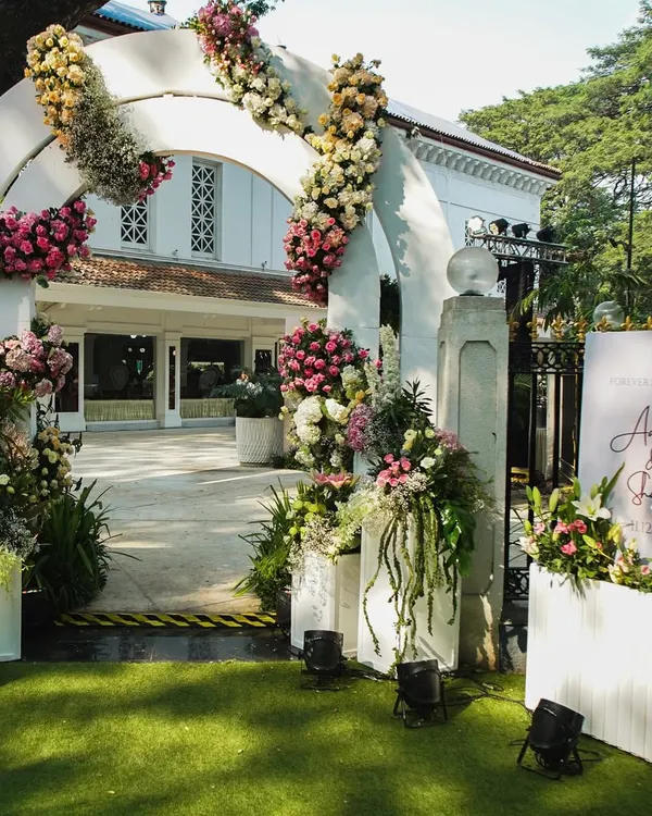 The entrance to a wedding should be a gateway to the magic inside. We created this grand floral archway to welcome guests to Aaliyah and Shane's beautiful white wedding.