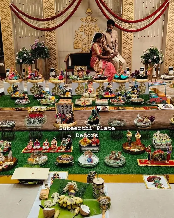 This is a complete engagement platter setup I designed, creating a beautiful and traditional centerpiece for the couple's special day. Notice how the numerous seer thattu (ceremonial plates) are arranged with fruits, sweets, and decorative items to create a grand display on the stage.