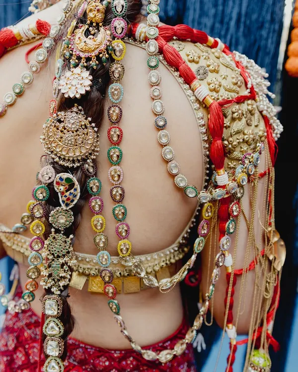A close-up on the incredible details of this heritage-inspired look. The makeup is flawless, but it's the intricate hair jewelry and blouse embroidery that tell a story of tradition and artistry.