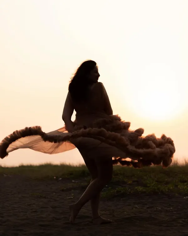 This is the magic I live to capture. A moment of pure freedom and joy, with your beautiful gown dancing in the sunset's glow. This solo maternity portrait is all about celebrating you and the life you are creating.